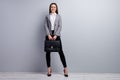 Full body photo of attractive business lady beaming smiling worker young promoted chief hold diplomat bag wear specs Royalty Free Stock Photo