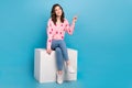 Full body photo of attractive woman cube point empty space dressed stylish pink strawberry print outfit isolated on blue