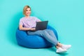 Full body photo cadre of young sitting beanbag girl programmer use netbook chatting with customers isolated on