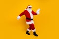 Full body photo of charismatic crazy santa dancing enjoy new year clubbing isolated on yellow color background