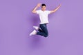 Full body photo of cheerful young happy man jump up air active good mood isolated on purple color background
