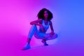 Full body photo of cool fitness blogger squat advertise trendy outfit isolated on pink blue color neon background