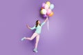 Full body photo of crazy funky feminine girl hold hand catch many baloons flying sky scream wow omg wear soft pink