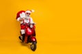 Full body photo of crazy funny santa claus in red hat drive hurry fast motor cycle hold sack christmas x-mas preparation Royalty Free Stock Photo