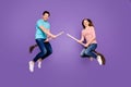 Full body photo of crazy two people guy lady jumping high sitting on witch brooms going theme party couple wear casual Royalty Free Stock Photo