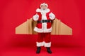 Full body photo of excited elderly aviator santa impressed by speedy adventure journey show thumb up scream wow wear Royalty Free Stock Photo