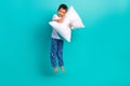Full body photo of excited small person jumping hands hold comfort cushion empty space isolated on teal color background