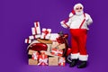 Full body photo of fat santa man with many giftboxes on bike advising low final sale prices stretching red suspenders