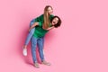 Full body photo funky laughing couple riding girl piggyback joking together looking empty space at party isolated on