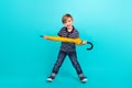 Full body photo of funky little boy hold umbrella wear t-shirt jeans sneakers isolated on teal background Royalty Free Stock Photo