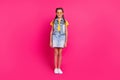 Full body photo of funky school blond girl stand wear glasses t-shirt vest skirt shoes isolated on fuchsia color Royalty Free Stock Photo
