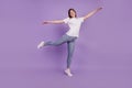 Full body photo of girl hold hands planes outfit isolated over purple background