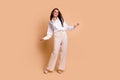 Full body photo of gorgeous peaceful classy lady feel comfortable dancing empty space isolated on beige color background