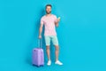 Full body photo of handsome young guy luggage telephone eticket device dressed stylish pink clothes isolated on