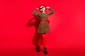 Full body photo of happy nice cheerful old woman wear hat sunglass go weekend isolated on red color background