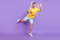 Full body photo of happy positive man wave hello make picture wooden frame isolated on violet color background Royalty Free Stock Photo