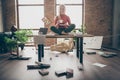 Full body photo of happy trader woman sit on table crossed legs feel carefree careless rest relax hold white coffee cup