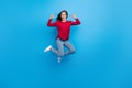 Full body photo of hooray millennial lady jump index herself wear eyewear shirt jeans shoes isolated on blue background Royalty Free Stock Photo