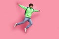 Full body photo of jumping indian guy green sweatshirt hands wings ready for next semester with backpack isolated on Royalty Free Stock Photo