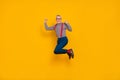 Full body photo of laughing cheerful granddad jumping up in excitement celebrate victory isolated on yellow color Royalty Free Stock Photo