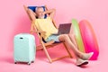Full body photo nap sleepy senior man hands head lying sunbed comfort watching netbook business course isolated on pink