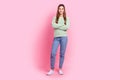 Full body photo of optimist young lady wear green sweater denim jeans casual outfit crossed arms isolated on pink color