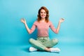 Full body photo of positive calm woman sit crossed legs meditate yoga show om symbol wear white shoes outfit isolated