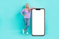 Full body photo of positive person demonstrate empty space big telephone display isolated on teal color background