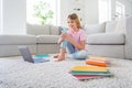 Full body photo of positive small kid girl sit floor carpet study remote use smart phone comment share repost classmate