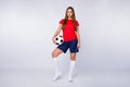 Full body photo professional footballer captain girl ready start exercise before world cup championship match hold foot