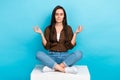 Full body photo of relaxation meditation young woman sitting platform closed eyes practice yoga chill isolated on blue Royalty Free Stock Photo