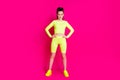 Full body photo of serious sportswoman aerobics trainer put hands waist isolated over pink bright color background