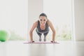 Full body photo of sportive positive woman doing plank exercise feel energy stretch her elbows like feelings of