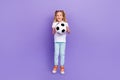 Full body photo of sporty little girl tails goalkeeper jump catch ball wear stylish white look on violet color