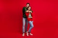 Full body photo of two idyllic peaceful partners cuddle empty space ad festive time on red color background