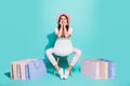 Full body photo upset girl sit chair with shopping bags look empty space difficult choice concept on turquoise