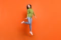 Full body photo of young attractive energetic girl happy smile jump up isolated over orange color background