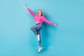 Full body photo of young carefree flying wings hands abstract girl wear her new outfit jeans sweater jump isolated on Royalty Free Stock Photo