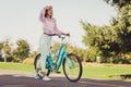 Full body photo of young cheerful african girl happy positive smile look forward nature park bicycle summer weekend Royalty Free Stock Photo