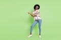 Full body photo of young cheerful afro girl happy positive smile point fingers empty space dancer isolated over green