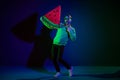 Full body photo of young cheerful man happy positive smile hold big watermelon slice isolated over dark color background