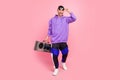 Full body photo of young cool guy ego party hold boombox music lover isolated over pink color background