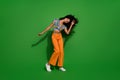 Full body photo of young discotheque dancer in nightclub meloman with chevelure hair girl shaking head  on green Royalty Free Stock Photo