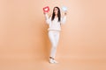 Full body photo of young girl amazed surprised look empty space hold paper card message like isolated over beige color Royalty Free Stock Photo