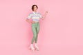 Full body photo of young girl happy smile roller skater point finger empty space ad choice isolated over pink color Royalty Free Stock Photo