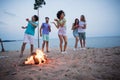 Full body photo of young guys ladies drink beer dance near fire wear casual cloth by the beach Royalty Free Stock Photo