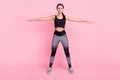 Full body photo of young serious woman warm-up stretch motivation sport isolated on pink color background