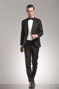 Full body pictrue of a man in tuxedo walking forward Royalty Free Stock Photo