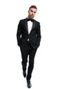 Elegant young man in black tuxedo holding hands in pockets Royalty Free Stock Photo