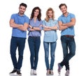 Full body picture of four casual young smiling people